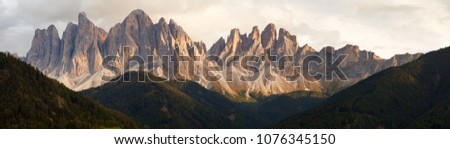 evening panoramic view of Geislergruppe or Gruppo dele Odle, Italian Dolomites Alps mountains Royalty-Free Stock Photo #1076345150