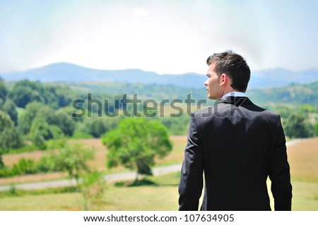 Business man standing in nature