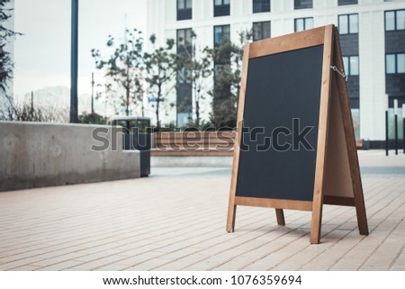 Blank Sandwich Board at the Street Near skyscrapers. Business Center, Commercial Center, Downtown.  Copy Space, Empty Space for Advertising