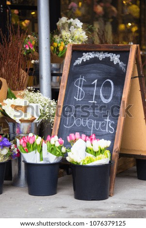Charming florist sidewalk display of flowers and sign