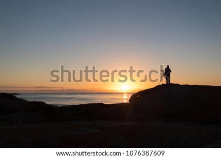 photographer at dawn, The Blow Hole, Tasmania