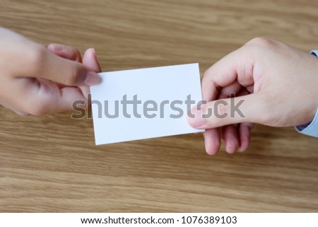 Hand giving blank white business card with copy space for text, business mock up background concept 