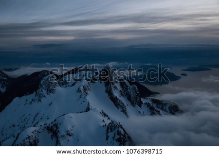Striking and beautiful snow covered Canadian mountain landscape. Taken from an Aerial perspective North of Vancouver, British Columbia, Canada.