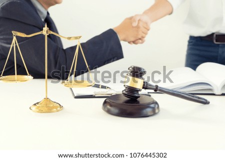 Justice lawyers Handshake to businessman or client for law agreement with Judge gavel. advice and justice law firm concept.
