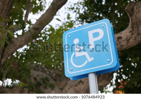 disable parking badge reserved for vehicles used by people with disabilities, blue sign in public