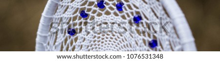 Banner of Blue and white Dreamcatcher made of feathers leather beads and ropes, hanging
