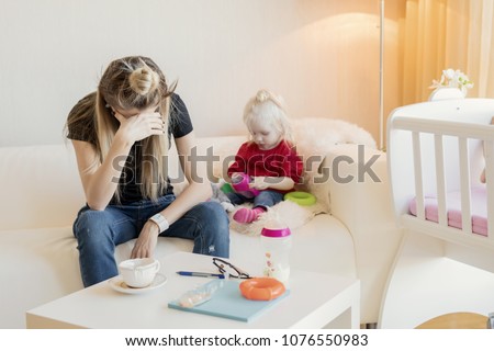 Mom exhausted by babysitting Royalty-Free Stock Photo #1076550983