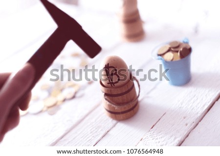 The hand holds a hammer against the background of an egg with bitcoin