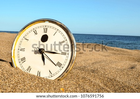 Photo Picture of a Clock on the Sand Beach