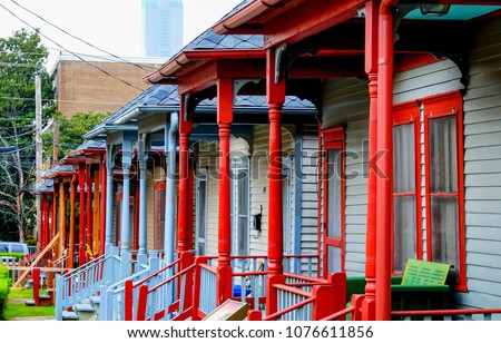 A row of colourful wooden porches of the social housing on Auburn Avenue, Atlanta, Sweet Auburn District, Atlanta USA these houses are directly opposit the house that Martin Luther King was born in. Royalty-Free Stock Photo #1076611856