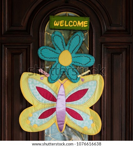 Photo of a front door with a decorated welcome sign.