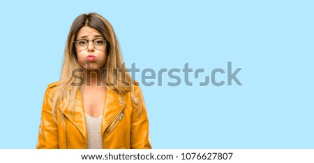 Beautiful young woman puffing out cheeks, having fun making funny face