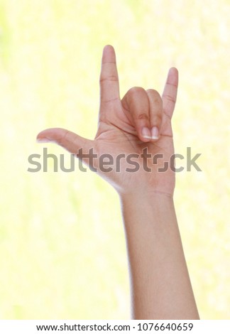Woman hand sign I Love You language gesture.