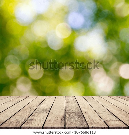 Old wood table with abstract natural green blurred bokeh background for product display 