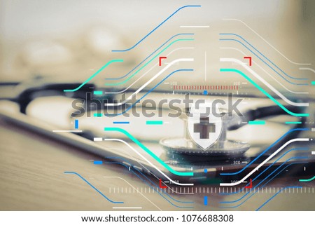 Health protection. Medical and health care concept.Studio macro of a stethoscope and digital tablet with shallow DOF evenly matched abstract on wood table 