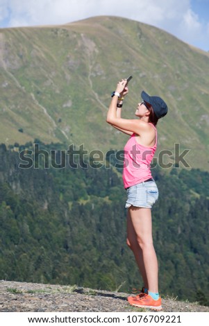 Photo of woman photographed herself against of mountains