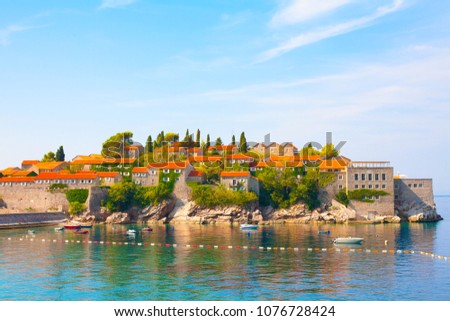 Beautiful view of the famous sight of Montenegro Sveti Stefan island on Budva Riviera. Luxury resort place in the Adriatic Sea in summer sunny day. Horizontal Wallpaper