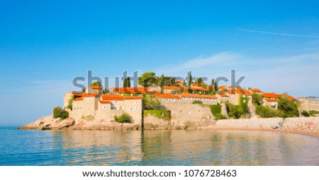 Scenic Wide panoramic view of the famous landmark of Sveti Stefan island on Budva Riviera. St Stephen island is must see sight in Montenegro. Luxury resort in the Adriatic Sea in summer.