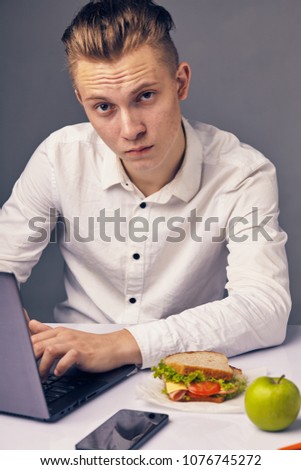 Businessman while lunch at the office looking at camera