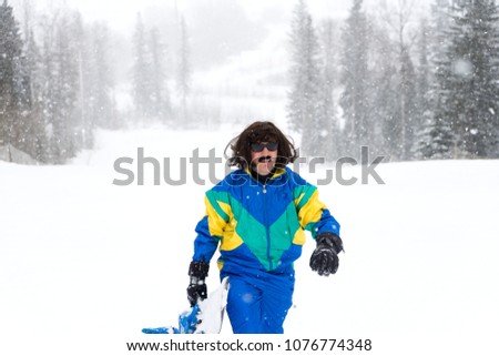 Vintage photo of young man snowboarder in the mountains. Retro style. 1980 concept.