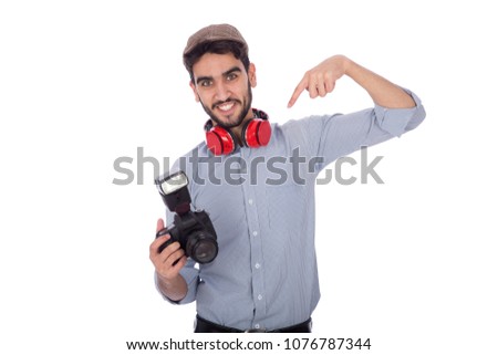 Photographer wearing a classic outfit, pointing his finger at the camera, on his face big smile, isolated on white background