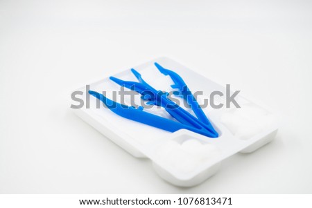 Medical nursing set contains of tweezers, gauze pieces with white tray isolated, Handle plastic clip, cotton and wound dressing,Set of dressing, simple plastic set on white background,
