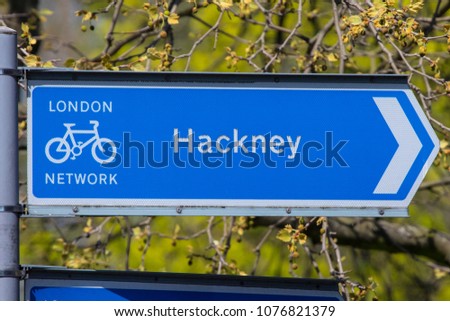 A directional sign for cyclists pointing towards the Hackney area of London in the UK. Royalty-Free Stock Photo #1076821379