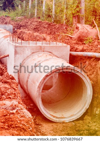 Concrete Drainage Pipe on a Construction Site .Concrete pipe stacked sewage water system aligned on site.Roll concrete at work site.