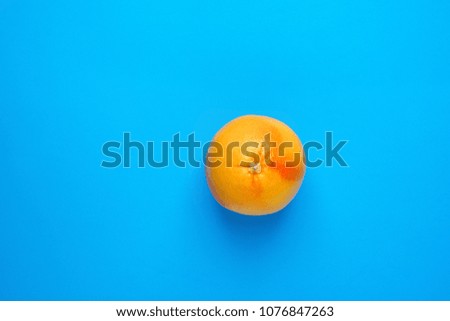 Ripe Juicy Whole Grapefruit on Solid Blue Background. Vitamin C Healthy Diet Summer Detox Vegan Tropical Fruits Creative Food Concept. Poster Banner Template. Copy Space Flat Lay