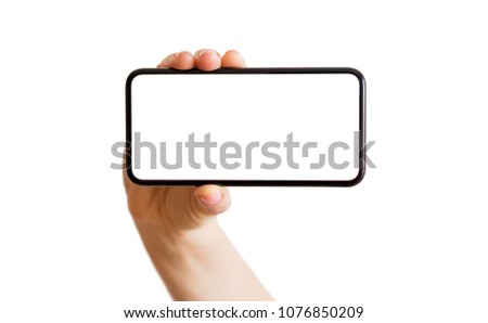 Person holding phone with empty white screen horizontally. Mobile app mockup.