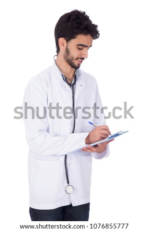 Side shot of a handsome doctor wearing his coat and stethoscope holding a pen and a paper, writing a description, isolated on white background