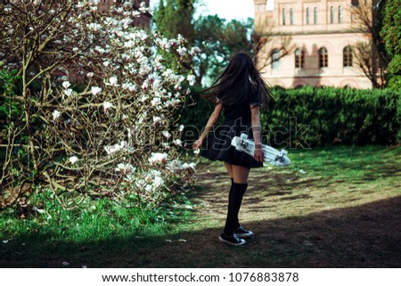 A girl near bloom magnolia in university