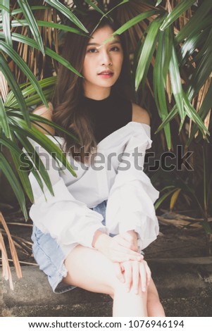 Portrait of thai Jeans skirt white shirt adult beautiful girl relax and smile