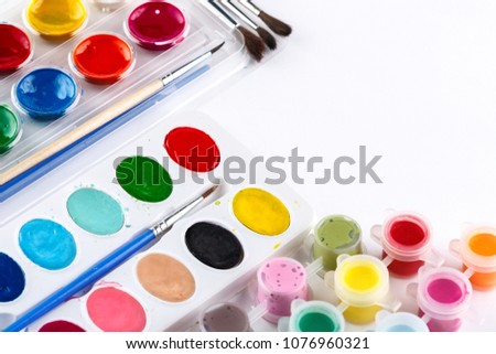 Watercolor children paint and brush in box, isolated on white background. school fees. Copyspace