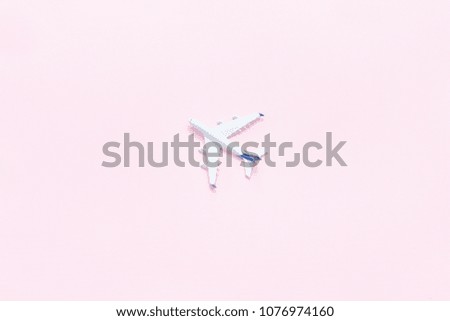 Travel concept. Airplane on a pink background. Place for text. 