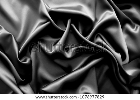 Smooth elegant black / dark grey satin silk  luxury cloth fabric texture, abstract background design. Copy space