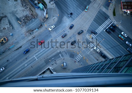 Looking down onto Toronto streets from a skyscraper apartment balcony near the waterfront in Toronto, Ontario Canada. Multi-colored cars, concrete and construction 