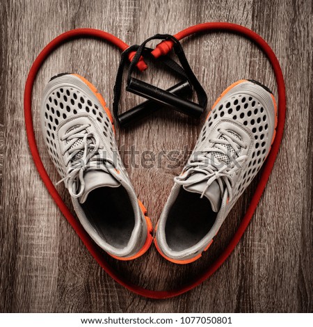 Heart shaped sneakers and red resistance band isolated