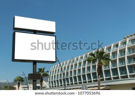 Empty billboard on the building background on a sunny day.