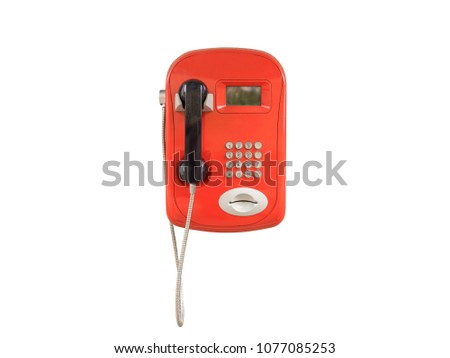 Red urban payphone. Isolated on white background. Close-up Royalty-Free Stock Photo #1077085253