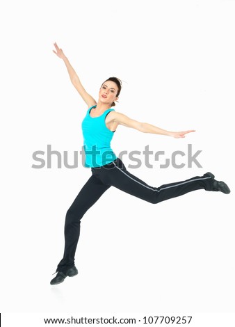 young woman in fitness outfit showing jumping moves on white background