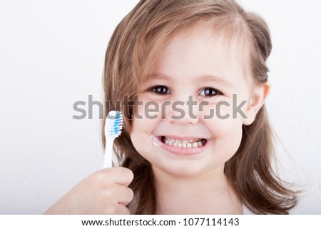 Cute little girl brushing her teeth