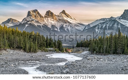 View of Three Sisters Mountain, well known landmark in Canmore, Canada Royalty-Free Stock Photo #1077137600