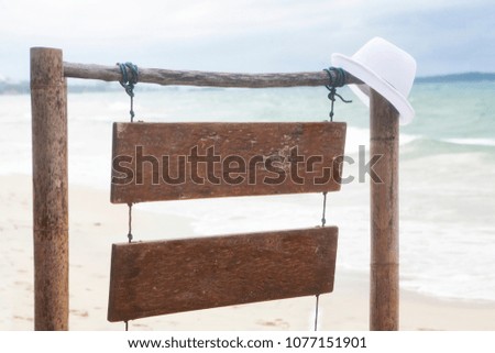 tropical style wooden empty sign up for inscriptions on the beach with sea view white sand. Concept for text about price place menu pointer warning on the beach Ocean entertainment in vacation concept
