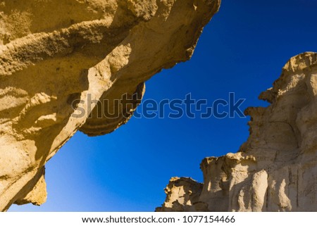Beautiful nature view from desert on stone mountains. Outdoor scenic pictures landscape of mountains, sand and rocks.