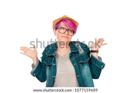 Totally indifferent young millennial model showing ignorance while shrugging with shoulders and looking away through glasses isolated on white. 