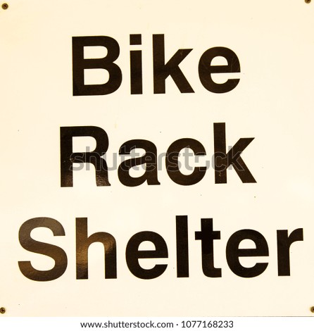 A sign advertising the presence of a bike rack shelter