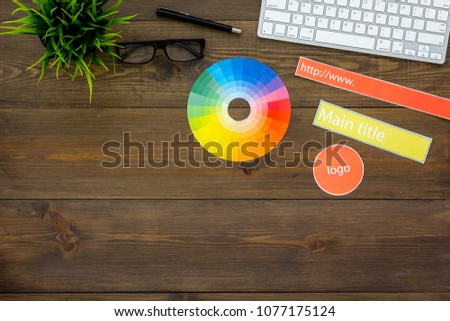 Design of website concept. Elements and blocks for building site on office desk near computer keyboard on dark wooden background top view space for text