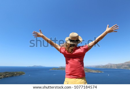 young woman enjoys beautiful see on the sea in summer vacation