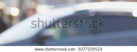Blurred background with silhouettes of cars.